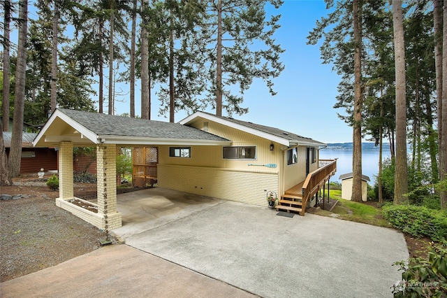 single story home featuring a water view and a carport