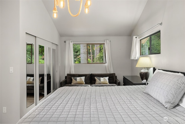 bedroom with lofted ceiling and a chandelier