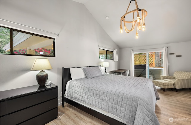 bedroom with high vaulted ceiling, a chandelier, and light wood-type flooring