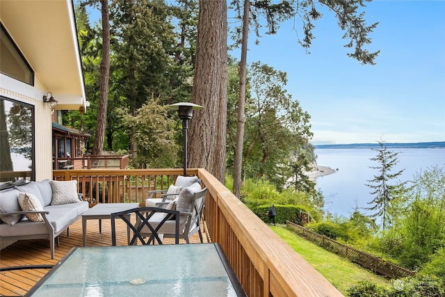 deck with a water view and an outdoor living space