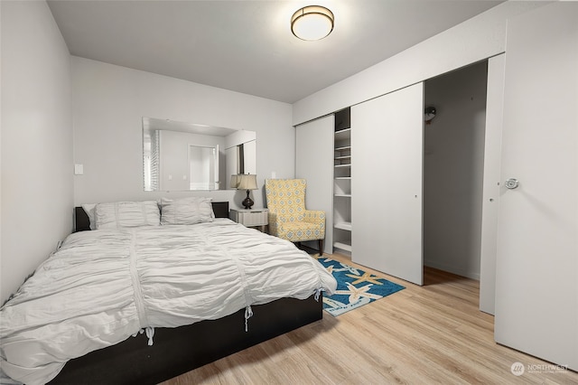 bedroom featuring light hardwood / wood-style flooring and a closet