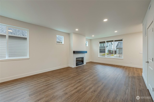 unfurnished living room featuring dark hardwood / wood-style flooring