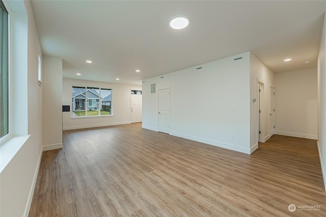 unfurnished living room with light hardwood / wood-style flooring