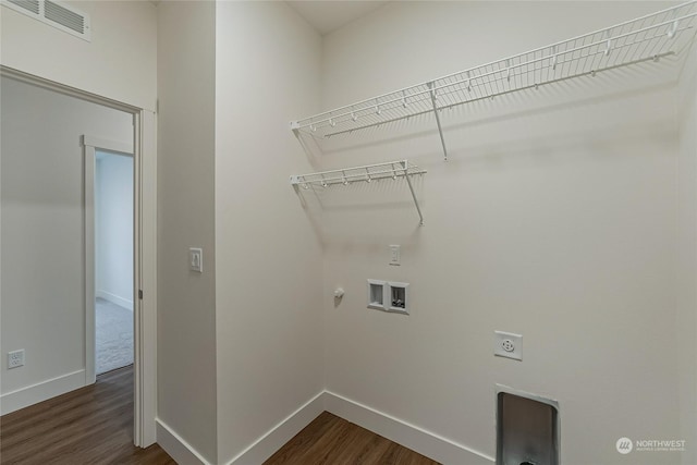 clothes washing area featuring hookup for a washing machine, dark hardwood / wood-style flooring, hookup for a gas dryer, and electric dryer hookup