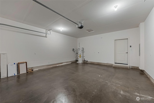 garage with strapped water heater and a garage door opener