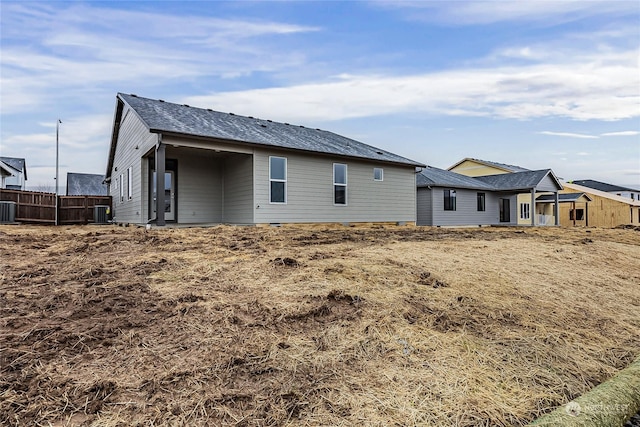 back of house with central AC unit