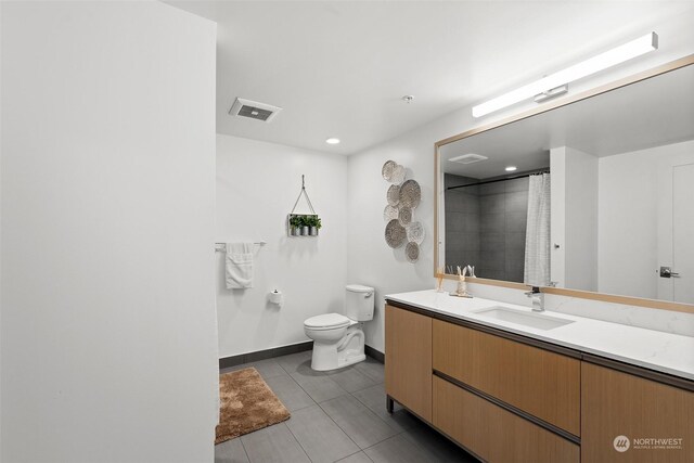 bathroom with toilet, tile patterned flooring, curtained shower, and vanity