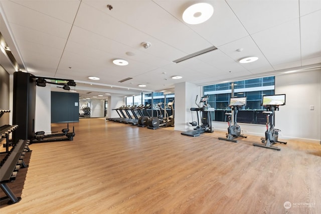 gym with light wood-type flooring and a wall of windows