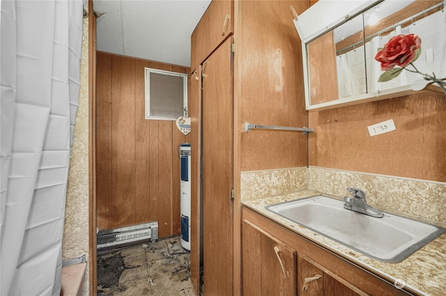 bathroom with vanity, electric water heater, and wooden walls