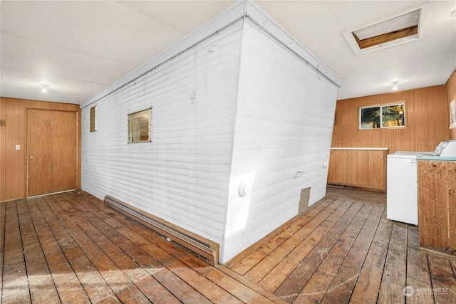 wooden terrace featuring separate washer and dryer and a baseboard heating unit