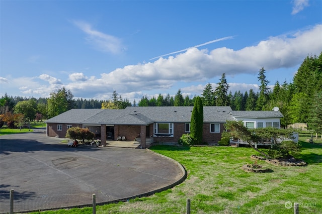 ranch-style house with a front yard and a garage