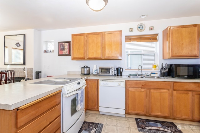 kitchen featuring white appliances and sink