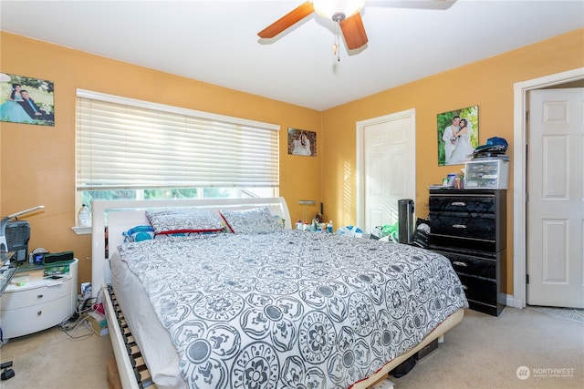 carpeted bedroom with ceiling fan