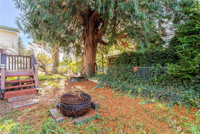 view of yard featuring an outdoor fire pit and a wooden deck