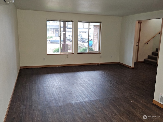 spare room with dark hardwood / wood-style floors