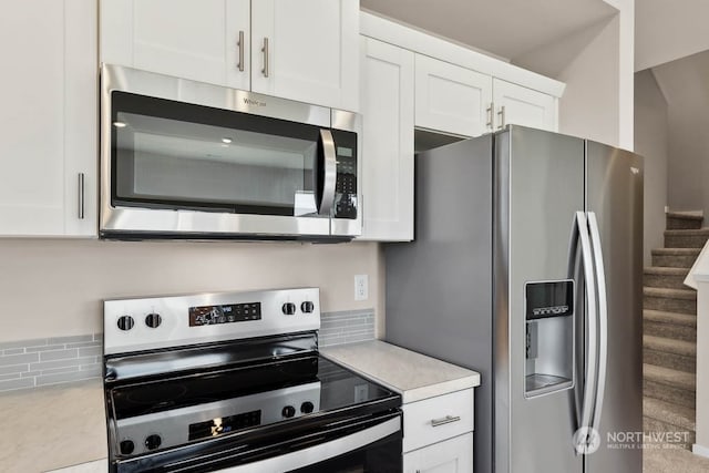 kitchen with appliances with stainless steel finishes and white cabinets