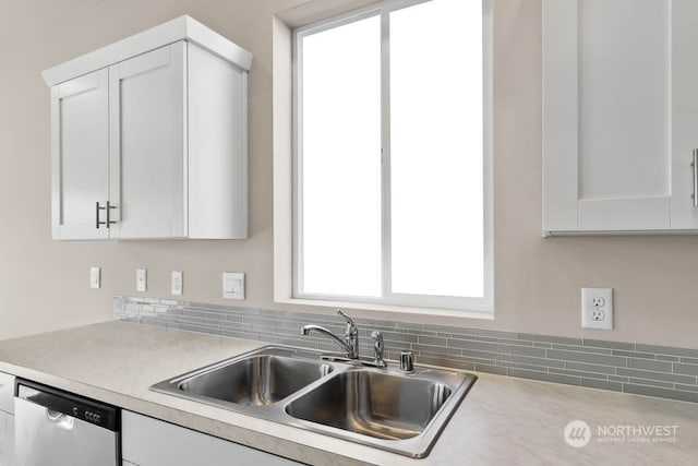 kitchen featuring white cabinetry, sink, a wealth of natural light, and dishwasher