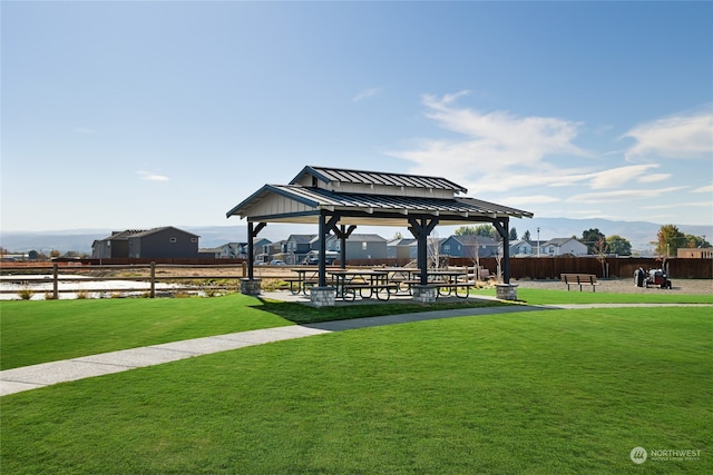 view of property's community with a gazebo and a lawn