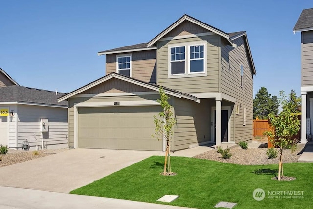 view of front of home with a garage and a front lawn