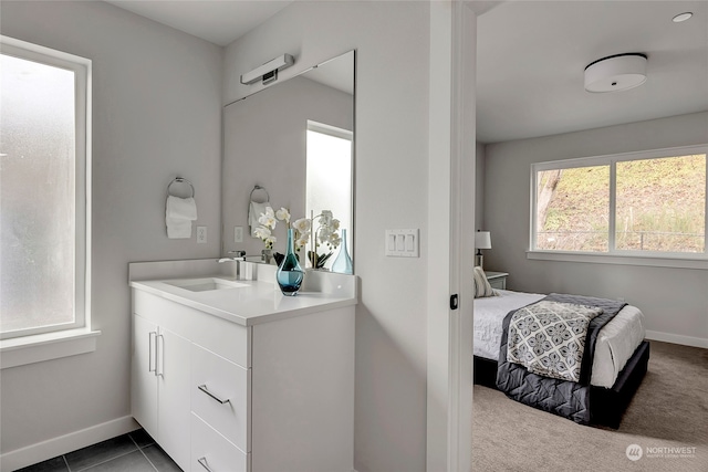 bathroom with a wealth of natural light, tile patterned floors, and vanity