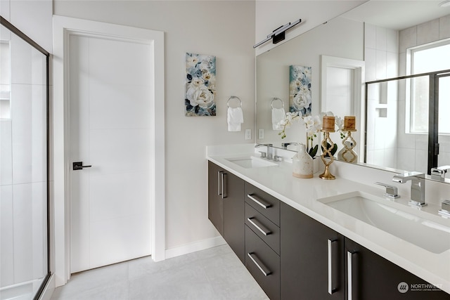 bathroom featuring tile patterned flooring, walk in shower, and vanity