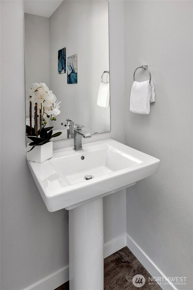 8904 NE 173rd Pl Unit B, Bothell, WA 98011 - bathroom featuring a sink, baseboards, and wood finished floors