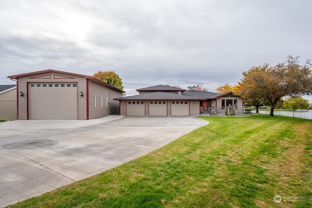 view of front of home with a front yard and a garage