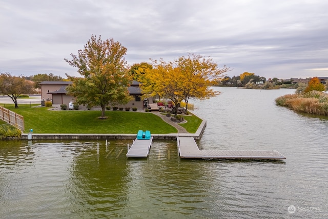 view of dock featuring a yard and a water view