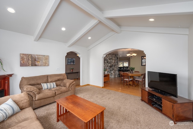 living room featuring a chandelier, vaulted ceiling with beams, and light wood-type flooring