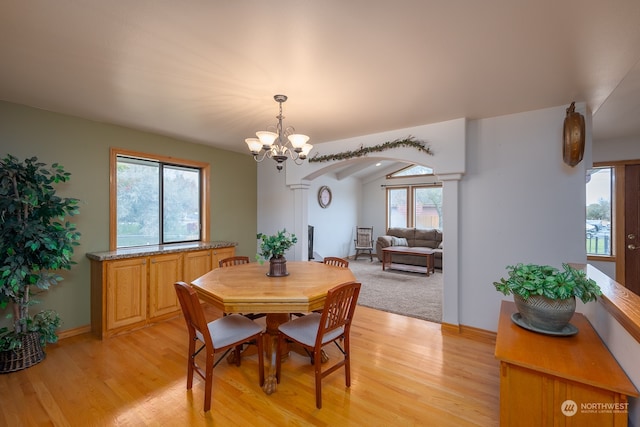 dining area featuring a chandelier, light hardwood / wood-style flooring, and plenty of natural light