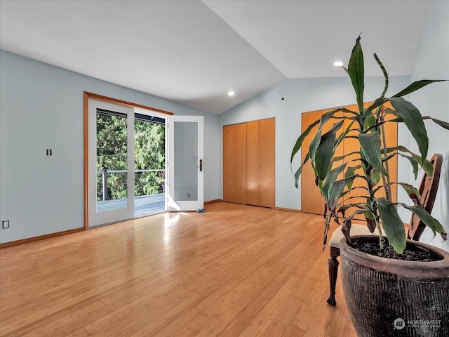 interior space featuring lofted ceiling and light wood-type flooring