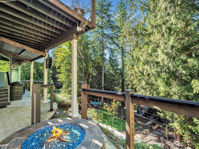 view of patio / terrace featuring an outdoor fire pit