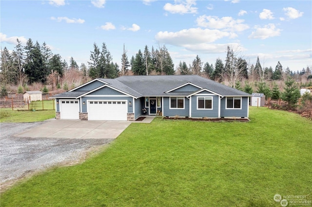 ranch-style house featuring a front yard and a garage