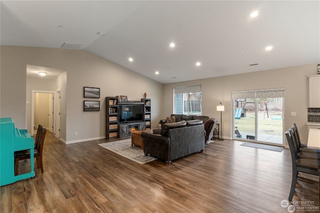 living room featuring vaulted ceiling and hardwood / wood-style flooring