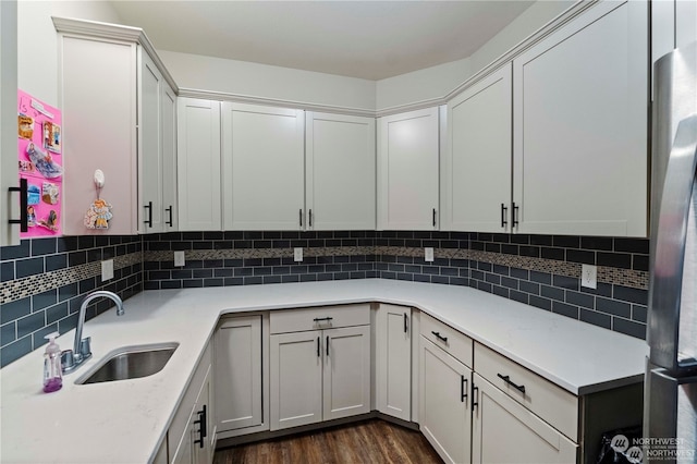 kitchen featuring sink, dark hardwood / wood-style floors, and white cabinets