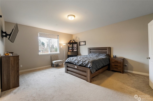 bedroom featuring light carpet