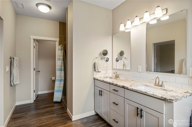 bathroom featuring vanity, decorative backsplash, a shower with curtain, and hardwood / wood-style floors