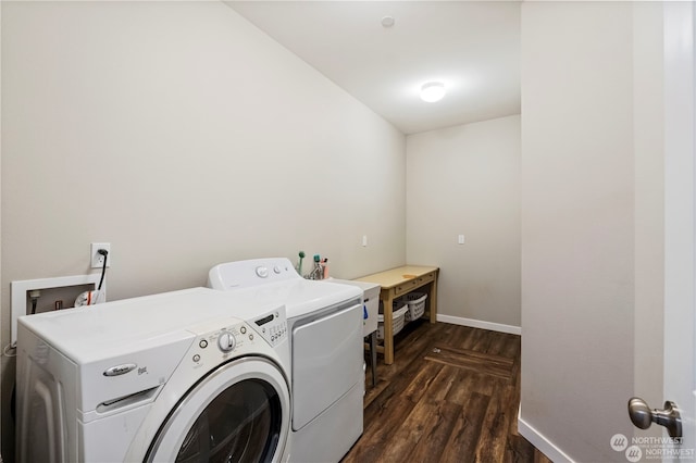 washroom with sink, washing machine and dryer, and dark hardwood / wood-style flooring