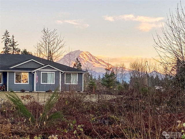 property exterior at dusk with a mountain view