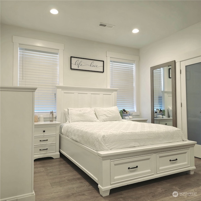 bedroom with dark hardwood / wood-style floors