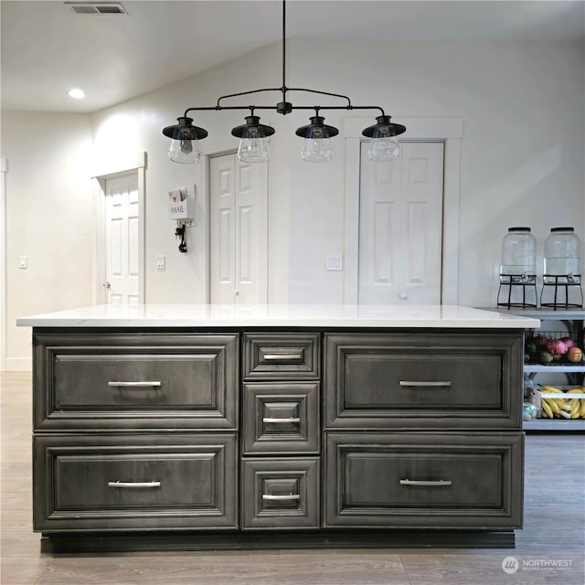 bar featuring hardwood / wood-style floors and pendant lighting