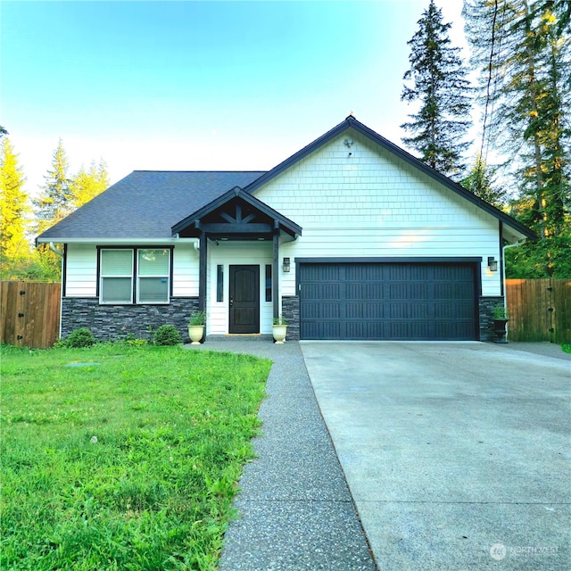 craftsman-style home with a front lawn and a garage