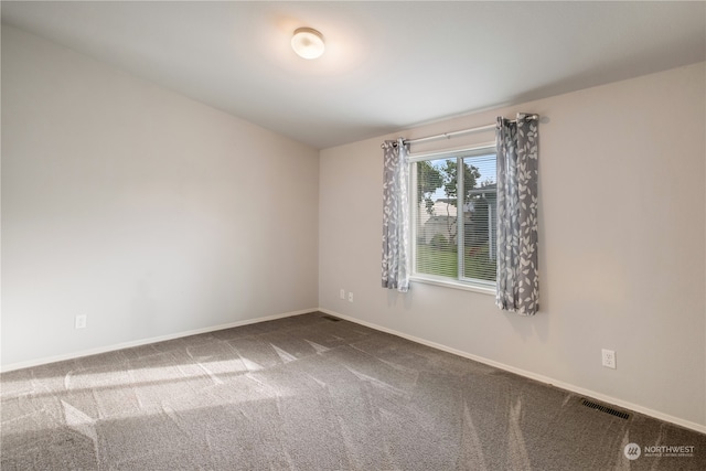 unfurnished room featuring carpet flooring