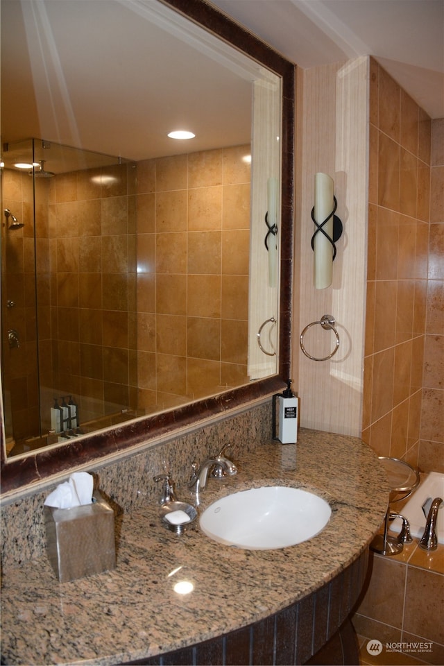 bathroom featuring vanity and an enclosed shower