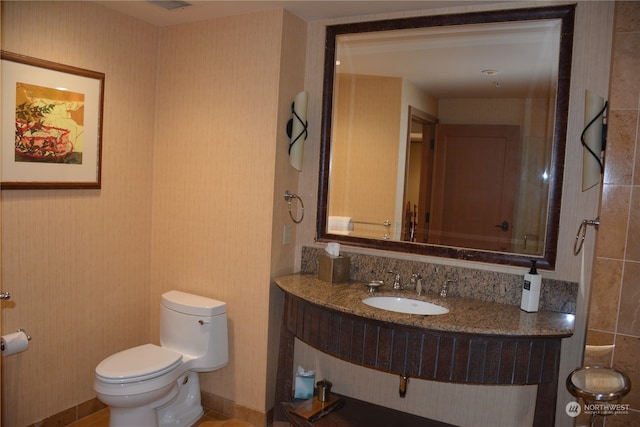 bathroom featuring vanity and toilet