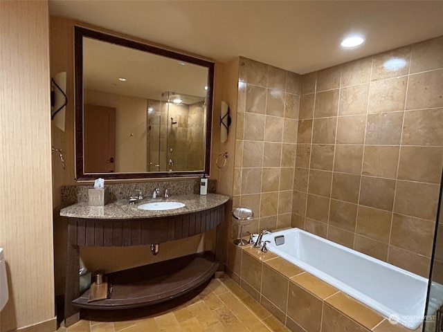 bathroom with vanity, tile patterned flooring, and plus walk in shower