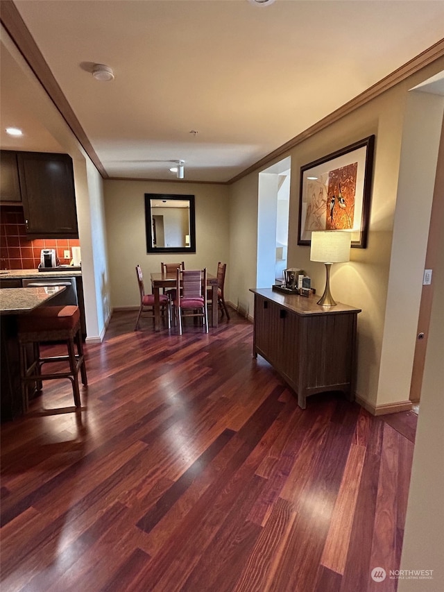 interior space featuring crown molding and dark hardwood / wood-style floors