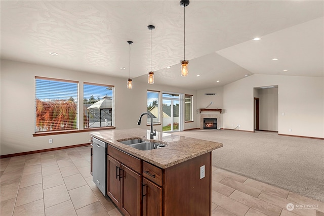 kitchen with dishwasher, a center island with sink, sink, hanging light fixtures, and light colored carpet