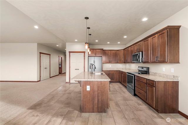 kitchen featuring sink, stainless steel appliances, pendant lighting, light carpet, and a center island with sink