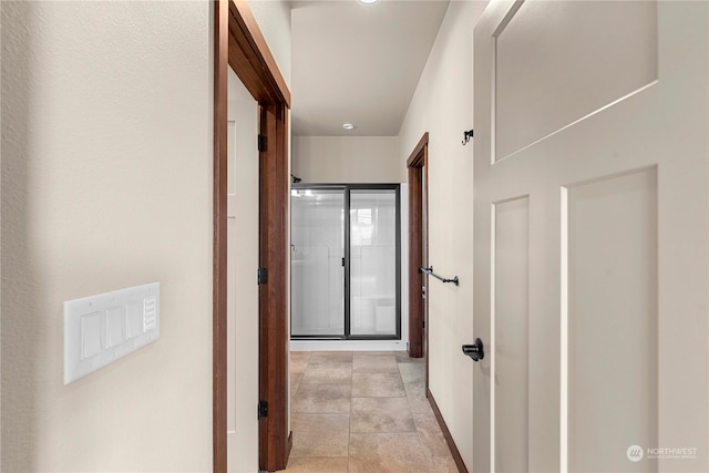 corridor featuring light tile patterned flooring